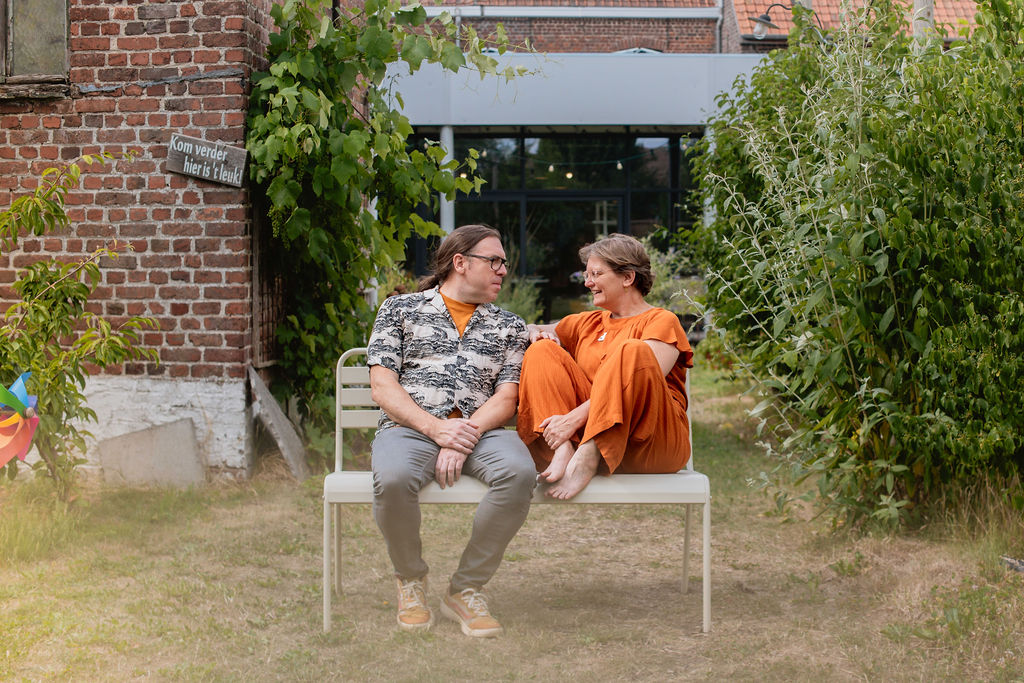Vanessa en Filip, begeleiders van Ruimte voor Wending, in de tuin van amba-amba in Desselgem